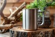 Stainless steel insulated mug with handle on wood coaster in a rustic setting