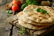 Pita bread on a wooden board with tomatoes basil and spices in a rustic culinary setting