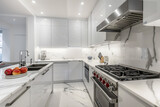 Fototapeta  - Modern Kitchen With Marble Countertops and White Cabinets