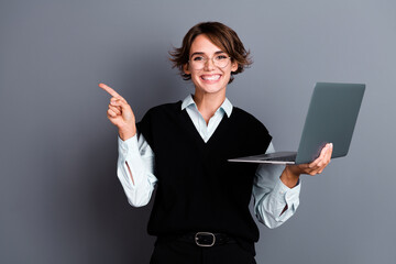 Sticker - Photo of cheerful lovely woman wear trendy black clothes presents novelty apple macbook isolated on grey color background