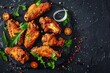 A plate filled with crispy fried chicken wings, accompanied by colorful garnishes, on a black background
