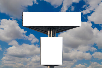 Wall Mural - front view: two blank white billboards or large displays against the blue sky with white clouds - mo
