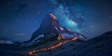 Fototapeta Niebo - Illuminated mountain peak at night with starry sky