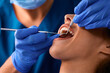 Close up of woman having her teeth examined by dentist.