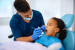 Small black girl during teeth examination at the dentist.