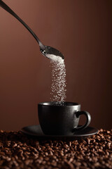 Sticker - Sugar is poured into a cup of coffee.