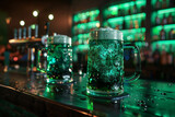 Fototapeta Tulipany - Two glasses of traditional green beer for st. Patrick's day celebration on bar counter. Copy space, background.