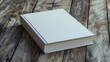 Blank white book on wooden table.