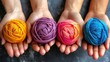 a group of three hands holding balls of yarn in different colors of the same skeine of yarn in each hand.