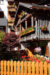 Wall Mural - Touristic view of Alleghe resort in the italian Dolomites on bright autumn day, Europe	