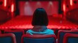 Teenage woman watching a film in the cinema