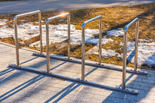 Bicycle Rack Made Of Chrome-plated Metal Pipes. Empty Bicycle Parking Close-up