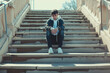 depressive guy sits on stairs