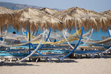 Fototapeta  - Sunbeds, Umbrellas and Hammocks in a beach