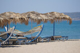 Fototapeta  - Sunbeds, Umbrellas and Hammocks in a beach