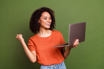 Canvas Print - Photo of pretty lucky woman wear orange t-shirt winning game modern gadget isolated green color background