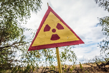 Sticker - Radioactivity sign on a cemetery in Pripyat abandoned city in Chernobyl Exclusion Zone, Ukraine