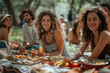 © bluebeat76 - Joyful friends enjoying picnic in park