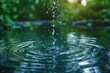 © DKPhoto - Crisp clear droplets of water falling into a tranquil pond, creating ripples on the water surface
