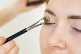 Fototapeta Na sufit - Makeup artist applying eye make up