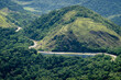 © Deni Williams - Aerial view of the Atlantic forest green vegetation mountains with Washington Luiz highway (BR-040) running around under summer afternoon sunny day near Petropolis, Rio de Janeiro - Brazil.