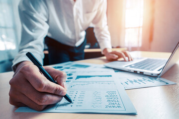 Businessman accountant or financial expert analyze business report graph and finance chart at corporate office. Concept of finance economy, banking business and stock market research. uds