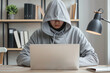 © Centric  - Focused Entrepreneur in Hoodie Using Laptop in Modern Office