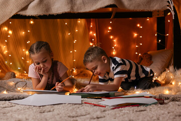 Canvas Print - Children drawing in play tent at home