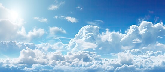 Poster - The vibrant sun is peeking through the cumulus clouds in the electric blue sky, creating a stunning meteorological phenomenon in the natural landscape