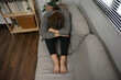 © Nanthida - Sad Young woman. Young woman at home living room sofa feeling sad tired.Young woman depressed emotion panic attacks.