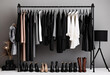 Closet with black hangers on a grey background, fashion studio concept, woman's and shoes on a rack, neutral colors of a black, white and beige palette, in the style of a neutral fashion shoot