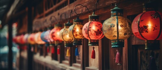 Poster - A row of vibrant lanterns adorns the wooden wall at a public event, creating a colorful and artistic display for the entertainment of the crowd