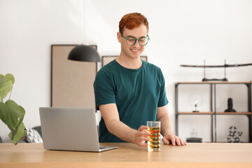 Poster - Young man with glass of juice at home