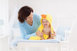 © famveldman - Mother and baby in towel after bath