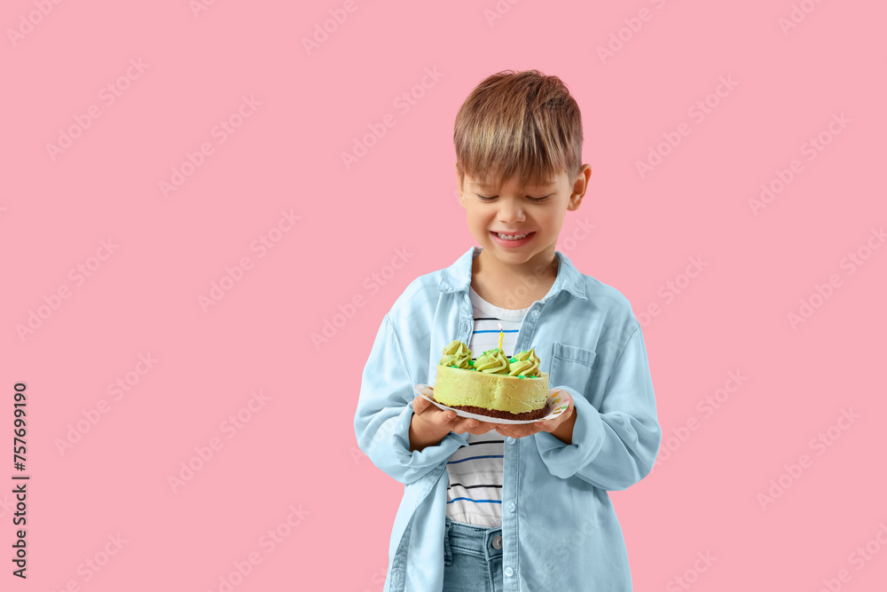 Cute little boy with Birthday cake on pink background