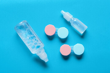 Poster - Containers for contact lenses with solutions on blue background