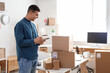 © Pixel-Shot - Male online store seller with notebook and parcel boxes in warehouse