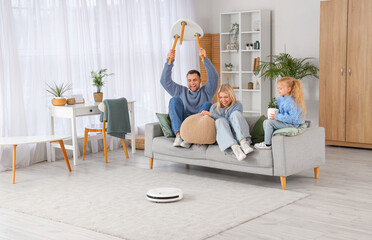 Poster - Family with lifted things and robot vacuum cleaner at home