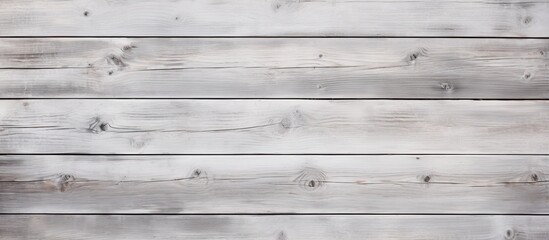 Poster - A close up photo of a rectangular grey hardwood plank flooring with a wood stain finish on a white wooden wall. The planks are parallel and create a stunning visual font