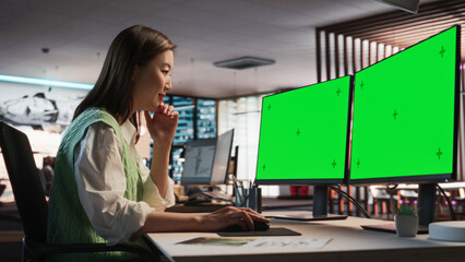 Aufkleber - Female Asian Game Designer Using Desktop Computer With Green Screen Chromakey on Display, Designing Characters In 3D Modeling Software For Survival Video Game. Woman Working In Game Development Office