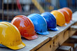 © PixMarket - Safety helmets lying on the wooden plank at a constriction site