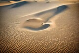 Fototapeta Uliczki - The wind-blown sand on a desolate dune forms a heart-shaped pattern that captures the essence of solitude in a huge expanse.