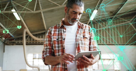 Canvas Print - Man with tablet overlaid by digital network icons, symbolizing global connectivity.