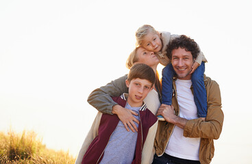 Wall Mural - Happy family, portrait and smile with field, walk and sunrise for morning exercise and bond. Parents, children and countryside for health, wellness and outdoor adventure at sunset for holiday