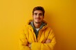 © MediaRaw - A man in a yellow jacket is smiling and posing for a picture