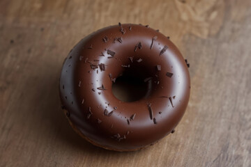 Chocolate Doughnut Sprinkled with Chocolate Chips on a Wooden Table