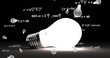 Image of light bulb icons and mathematical equations over light bulb on black background