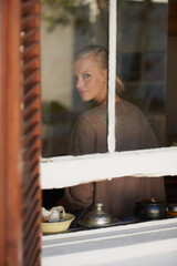 Poster - Portrait, woman and smile by window for relax with reflection, weekend break and calm expression in home. Person, face and happy with confidence, pride and casual clothes in apartment in winter