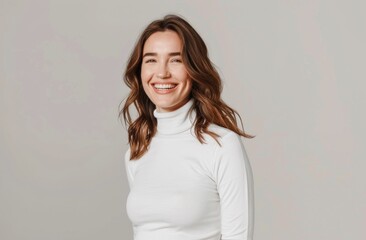 Wall Mural - A woman is smiling and wearing a white shirt. She is standing in front of a white background