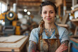 Skilled Tattooed Female Woodworker Smiling in Bright Workshop Space